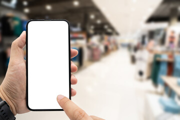 Hand holding blank screen smartphone for copy space on blurred clothing store. e-commerce app shopping mockup. social media, payment and shopping online concept. fashion and technology.