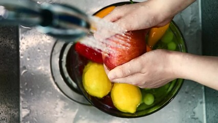 person washing fruit