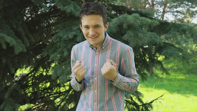 Man Giving Thumbs Up in Front of Tree