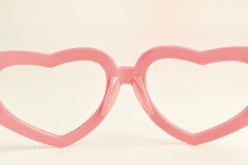 pink heart shape of glasses on pastel color background