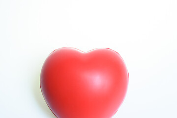 single red stress ball isolated on white background, heart shape toy