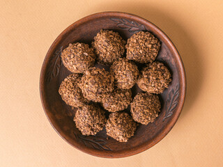 Healthy Homemade Chocolate Coconut Cookies in Rustic Wooden Bowl on Beige Background