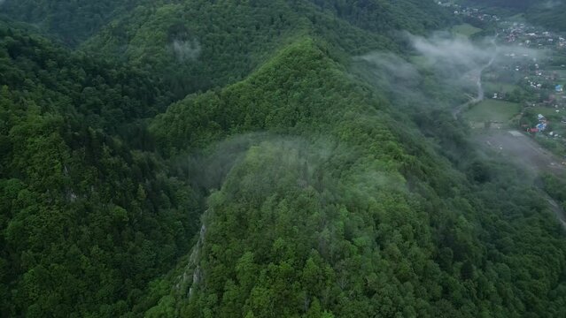 Wispy Clouds Over Forested Mountains Hiking Area Near Lepsa, Vrancea, Romania. Aerial Drone Shot