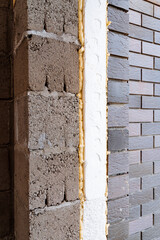 A closeup look at a brick wall with foam insulation. Keywords Wood, Building, Brickwork, Brick, Building material, Rectangle, Composite material, Automotive tire, Pattern, Metal