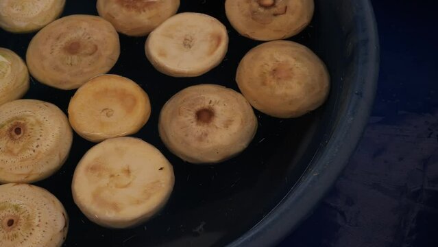 Peeled artichokes in plastic bowl at local market