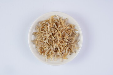 raw salted anchovies on a white background with studio lighting, in Indonesia is called 