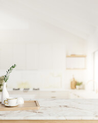 A space for displaying products on a white marble kitchen countertop in a minimalist white kitchen.