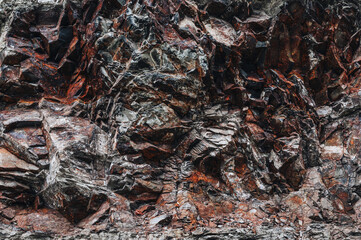 texture of an orange stone mountain with natural minerals in close-up