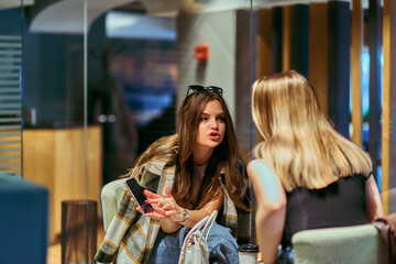 Catching Up and Connecting: Friends Enjoy Coffee and Conversation at a Cozy Cafe