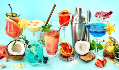 Summer colorful cocktails on blue background. Fresh tasty tropical drinks