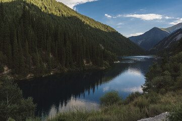 beautiful panoramic landscape with Kolsay Lake in the Tien Shan mountains in Kazakhstan on a summer evening