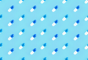 Seamless repetitive two-piece hard starch capsule pills on a soft blue background