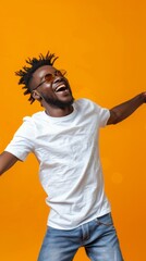 A man with dreadlocks is smiling and wearing sunglasses while jumping up