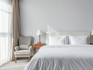 Modern hotel room with elegant bedding and stylish decor. Neutral tones and use of natural light.