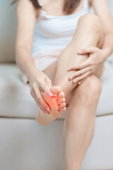 woman having barefoot pain at home. Foot ache due to Plantar fasciitis and waking longtime. Health and medical concept