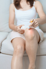 Arthritis and Muscle Pain Relief Cream concept. woman having knee ache and muscle pain due to Runners Knee or Patellofemoral Pain Syndrome, osteoarthritis, rheumatism and Patellar Tendinitis