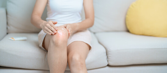 Arthritis and Muscle Pain Relief Cream concept. woman having knee ache and muscle pain due to...