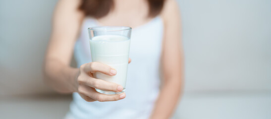 Milk drink and Daily Routine concept. Young woman Drinking milk with high calcium and nutrition at...