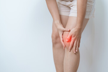 woman having knee ache and muscle pain due to Runners Knee or Patellofemoral Pain Syndrome,...