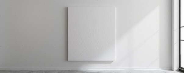 Minimalist white blank canvas on a white wall in a well-lit modern room, ideal for mockups, art presentations, or interior design inspiration.