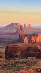 Monument Valley, a red-sand desert region on the Arizona-Utah border, is known for the towering sandstone buttes of Monument Valley Navajo Tribal Park