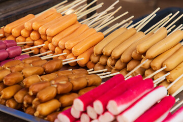 different foods on a stick for frying as a background.