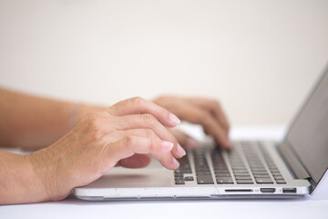 Closeup shot of female hands working on computer keyboard