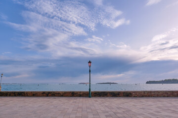 Seaside in Venice, street lamp. A lampstand on the promenade along the water.
