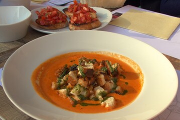 tomato soup with breadcrumbs in a white plate