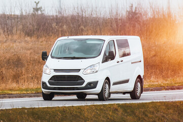 Fototapeta premium Commercial Delivery Van in Action on the Street. Sub Urban Logistics.