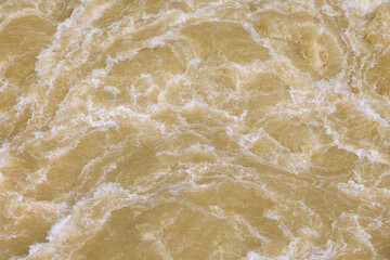 Churned up muddy brown water in the Lech after the 2024 flood of the century at Lake Mandicho