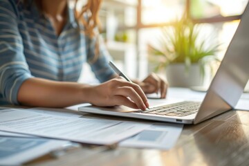 Fototapeta premium Person typing on laptop at desk