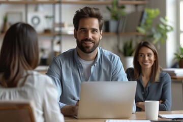 Couple smiling using laptop at table