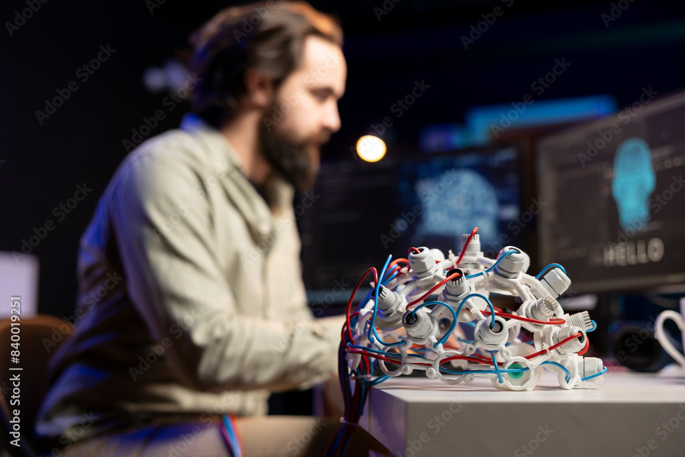 Poster focus on eeg headset used by engineer in blurry background to upload consciousness into computer. cl