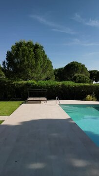 Drone view of a swimming pool of a house.Vertical Video