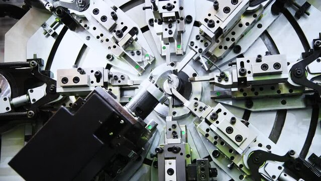 Close up of metal spring manufacturing machine at work