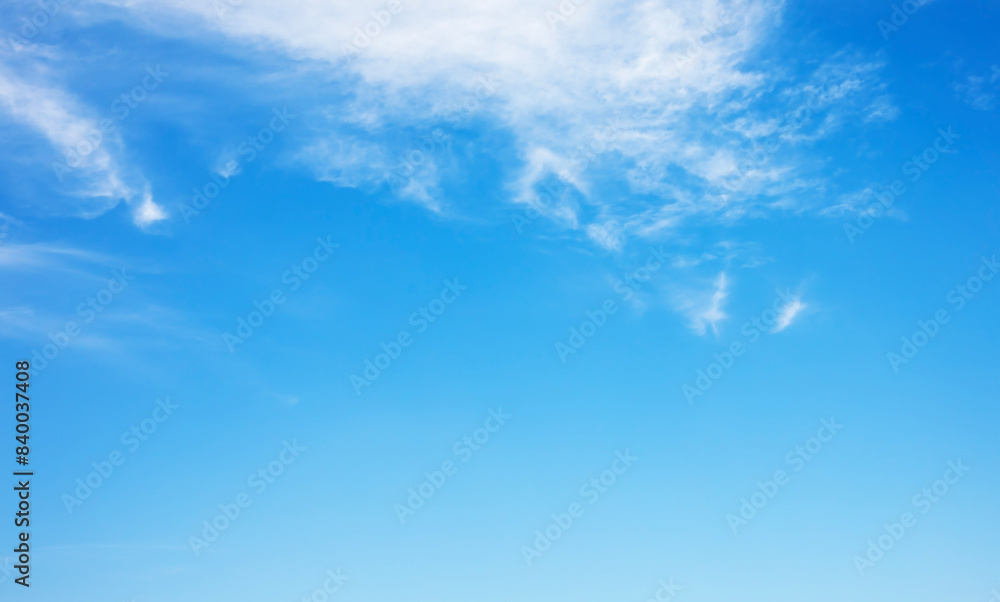 Wall mural fantastic soft white clouds against blue sky and copy space horizontal shape. web banner.website hea