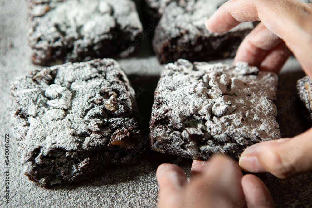 Sticker chocolate brownies on a dark background