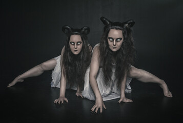 Two terrible ghost with horns on dark background