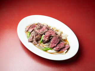 Meat tataki with vegetables on a plate