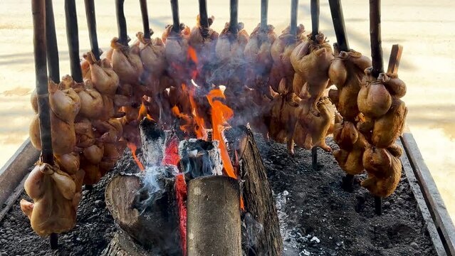 Traditional Balochi Chicken Sajji Roasted Over Open Fire in Pakistan