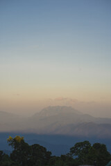 Naklejka premium travel and people activity concept with twilight sky before sunset with layer of mountain