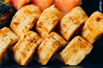 Delicious fresh and juicy roll prepared on the grill with salmon. With cream cheese, avocado, wasabi and ginger