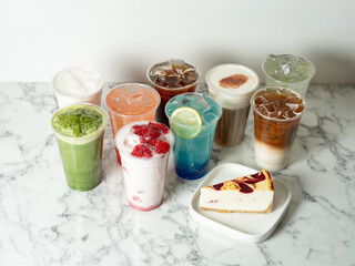 Various types of drinks and slices of cake