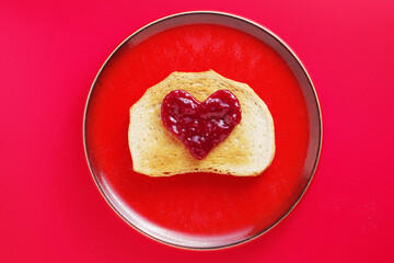 Toast with jam in the shape of a heart