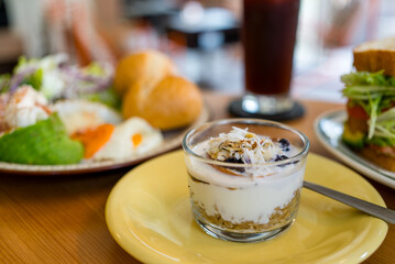Yogurt with cereal and blueberry in glass