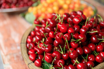 Fesh red cherry fruits in a container