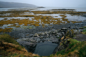 Hellulaug hot pool on the coast of Vatnsfjörður fjord in the Westfjords of Iceland.