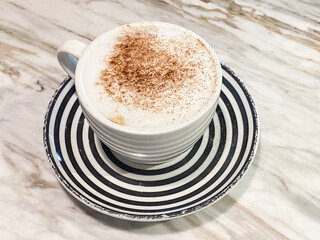 Creamy Cappuccino Topped with Sprinkled Cinnamon on Marble Table