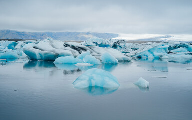 Icebergs floating in the lagoon beneath breidamerkurjokull glacier, jokulsarlon (glacial river...